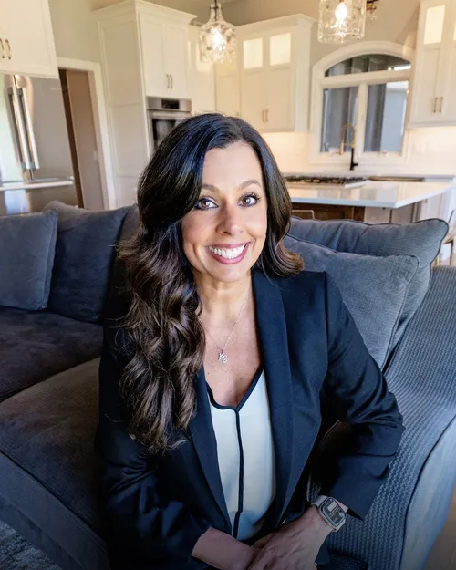 Jennifer Fallon, REALTOR®, seated in a navy blazer